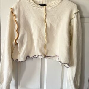 White sweater with colorful trim